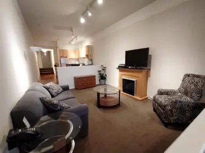 a living room with a couch and chairs and a television at Royal Harbour Resort in Thornbury