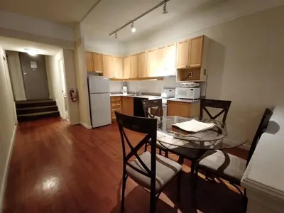 a small kitchen with a glass table and chairs at Royal Harbour Resort in Thornbury