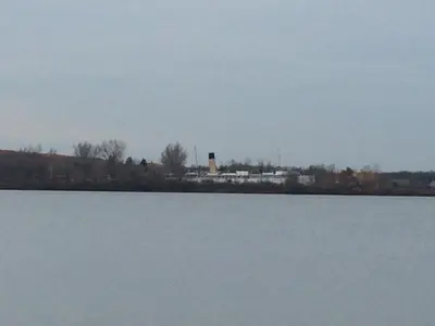 a large body of water with a silo in the background at Victoria Harbour Cottages in Victoria Harbour