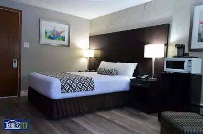 a hotel room with a bed and a tv at Travellers Inn in Hanover