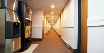 a long hallway of an office with a long corridor at Travellers Inn in Hanover