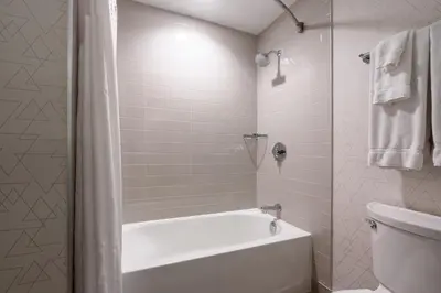 a white bathroom with a tub and a toilet at Holiday Inn Express & Suites Vaughan-Southwest by IHG in Vaughan