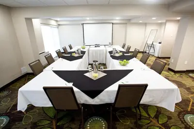 a conference room with a long table and chairs at Holiday Inn Hotel Peterborough Waterfront by IHG in Peterborough