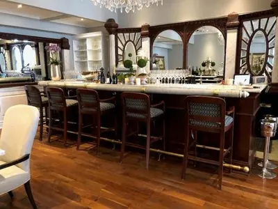 a bar with chairs and a counter in a room at Riverbend Inn & Vineyard in Niagara on the Lake