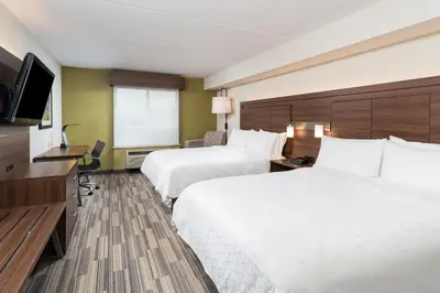 a hotel room with two beds and a flat screen tv at Holiday Inn Express Hotel & Suites Milton by IHG in Milton