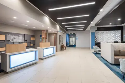 a lobby of a hospital with two large monitors at Holiday Inn Express Hotel & Suites Milton by IHG in Milton