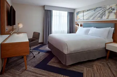 a hotel room with a bed and a desk and a bed sidx sidx sidx sidx at Four Points by Sheraton Hamilton - Stoney Creek in Hamilton