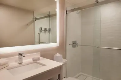 a bathroom with a sink and a shower at Four Points by Sheraton Hamilton - Stoney Creek in Hamilton