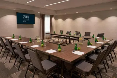 a conference room with a long table and chairs at Four Points by Sheraton Hamilton - Stoney Creek in Hamilton