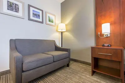 a living room with a couch and a table at Comfort Inn & Suites in Collingwood
