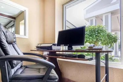 an office with a desk with a computer and a chair at Comfort Inn & Suites in Collingwood