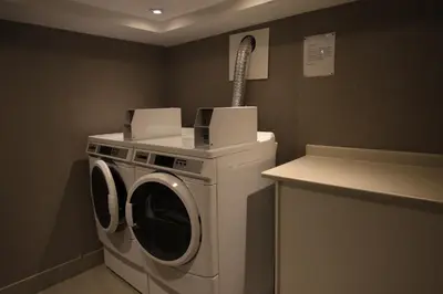 a washing machine with two boxes on top of it at Comfort Inn & Suites in Collingwood