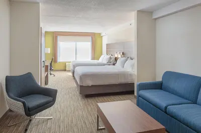 a hotel room with a bed and a couch at Holiday Inn Express & Suites - Belleville by IHG in Belleville