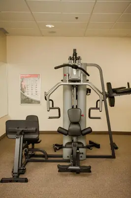 a gym with two exercise bikes in a room at Cambridge Hotel and Conference Centre in Cambridge
