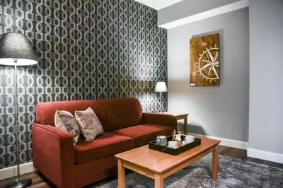 a living room with a couch and a table at Cambridge Hotel and Conference Centre in Cambridge