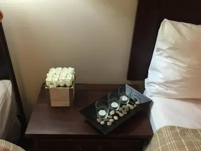 a table with cupcakes and candles on a bed at The Falls Family Lodge in Niagara Falls