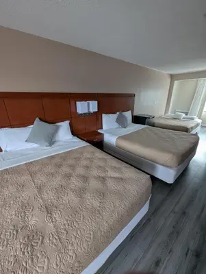 two beds in a hotel room with two at 7 Nights Stay in Niagara Falls