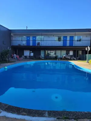 a large blue swimming pool in front of a building at 7 Nights Stay in Niagara Falls