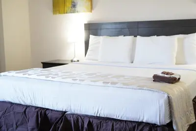 a bed with a teddy bear sitting on top of it at River Rapids Inn in Niagara Falls