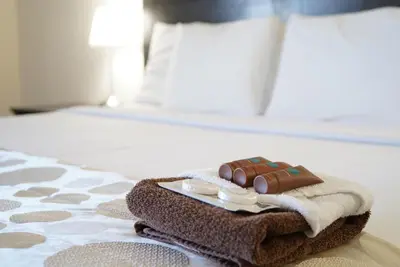 a piece of chocolate on a towel on a bed at River Rapids Inn in Niagara Falls