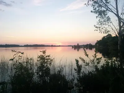 a view of a lake at sunset at All Tucked Inn in Waubaushene