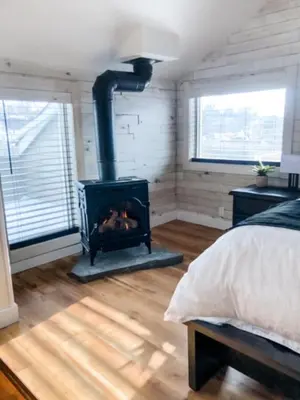 a bedroom with a wood stove in a room at Etherington Suites in Elora