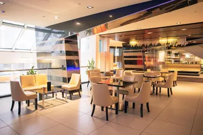 a restaurant with tables and chairs in a building at Hyatt Regency Toronto in Toronto