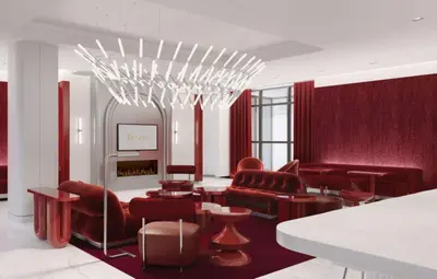 a living room with red furniture and a chandelier at Revery Toronto Downtown, Curio Collection by Hilton in Toronto