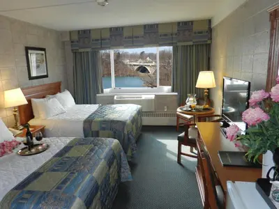 a hotel room with two beds and a window at Capri Inn in St. Catharines