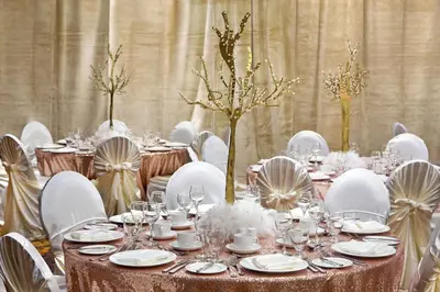 a long table with white chairs and tables with wine glasses at Doubletree by Hilton Toronto Airport, ON in Toronto