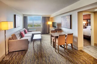 a hotel room with a couch and a table and a bed at Doubletree by Hilton Toronto Airport, ON in Toronto