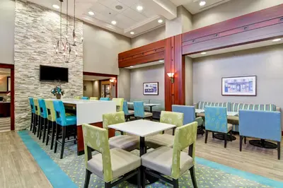 a dining room with a table and chairs at Hampton Inn & Suites Guelph in Guelph