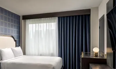 a hotel room with a bed and a window at The Brock Niagara Falls Fallsview, Tapestry by Hilton in Niagara Falls