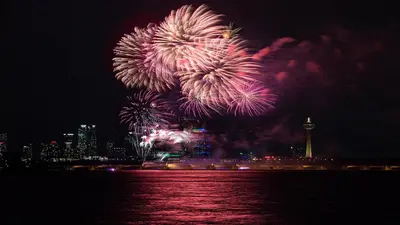 a fireworks display over the water with a city at Holiday Inn Niagara Falls-By the Falls by IHG in Niagara Falls