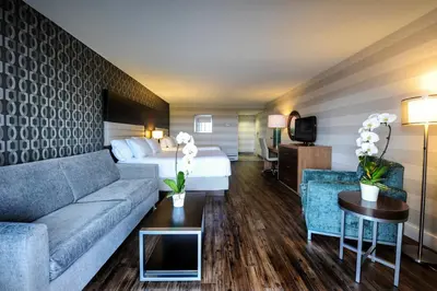 a hotel room with a couch and a bed at Holiday Inn Niagara Falls-By the Falls by IHG in Niagara Falls