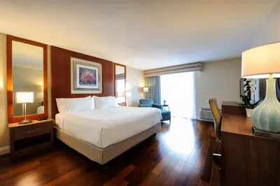 a hotel room with a large bed and a desk at Holiday Inn Niagara Falls-By the Falls by IHG in Niagara Falls