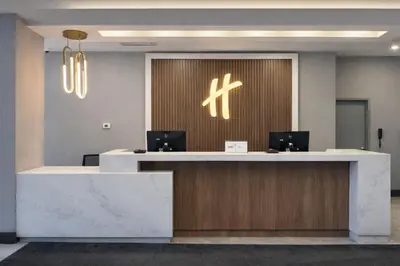 an office lobby with a reception desk with two computers at Holiday Inn & Suites Mississauga West - Meadowvale by IHG in Mississauga