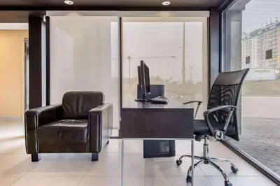 an office with a desk with a computer and a chair at Comfort Inn Airport West in Mississauga