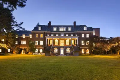 a large house with a large lawn in front of it at Spencer Hotel & Conference Centre in London