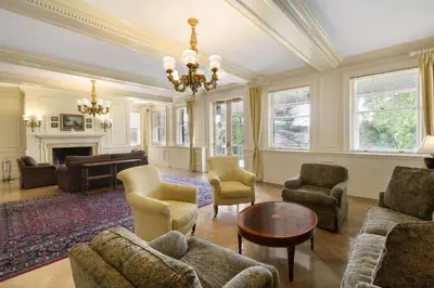 a living room filled with furniture and a chandelier at Spencer Hotel & Conference Centre in London
