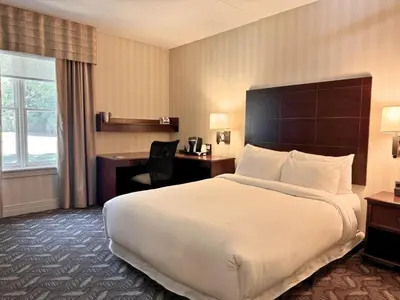 a hotel room with a large bed and a desk at Spencer Hotel & Conference Centre in London