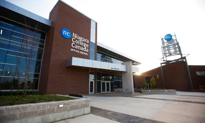 a building with a sign on the side of it at Residence & Conference Centre - Welland in Welland