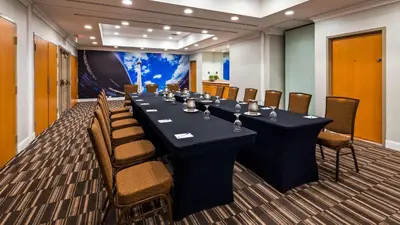 a conference room with a long table and chairs at Best Western Premier Toronto Airport Carlingview Hotel in Toronto