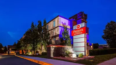a building with a sign on the side of it at Best Western Premier Toronto Airport Carlingview Hotel in Toronto