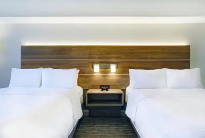 two beds sitting next to each other in a hotel room at Holiday Inn Express Whitby Oshawa by IHG in Whitby