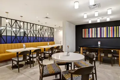 a restaurant with tables and chairs in a room at Holiday Inn Express Whitby Oshawa by IHG in Whitby