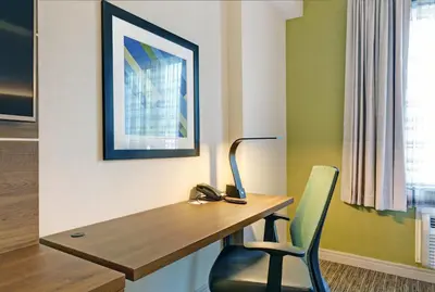 a office with a desk and a chair and a picture at Holiday Inn Express Whitby Oshawa by IHG in Whitby
