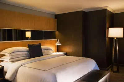 a bedroom with a large white bed and two lamps at The Yorkville Royal Sonesta Hotel Toronto in Toronto