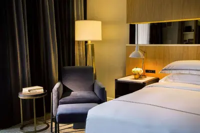a hotel room with a bed and a chair at The Yorkville Royal Sonesta Hotel Toronto in Toronto