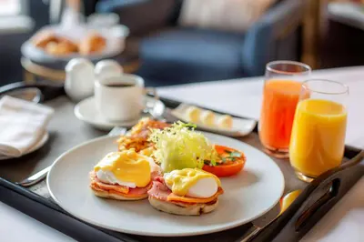 a table with a plate of breakfast foods and drinks at The Yorkville Royal Sonesta Hotel Toronto in Toronto